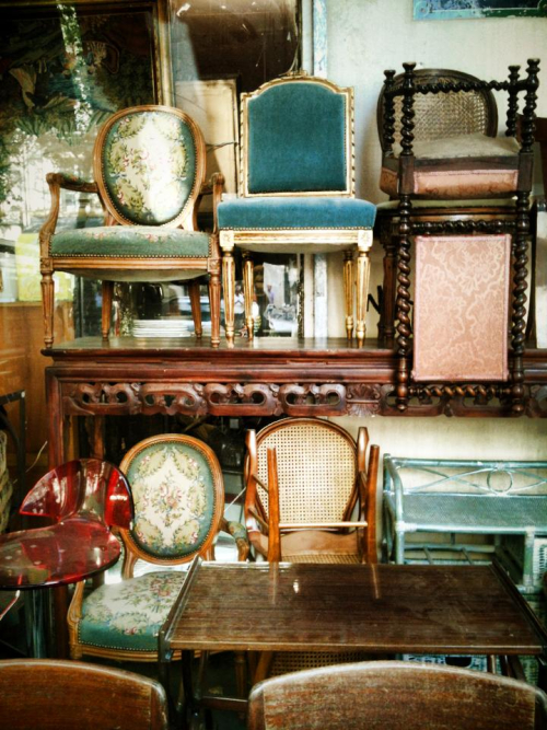 Chairs stacked up  waiting for a table to cozy up to